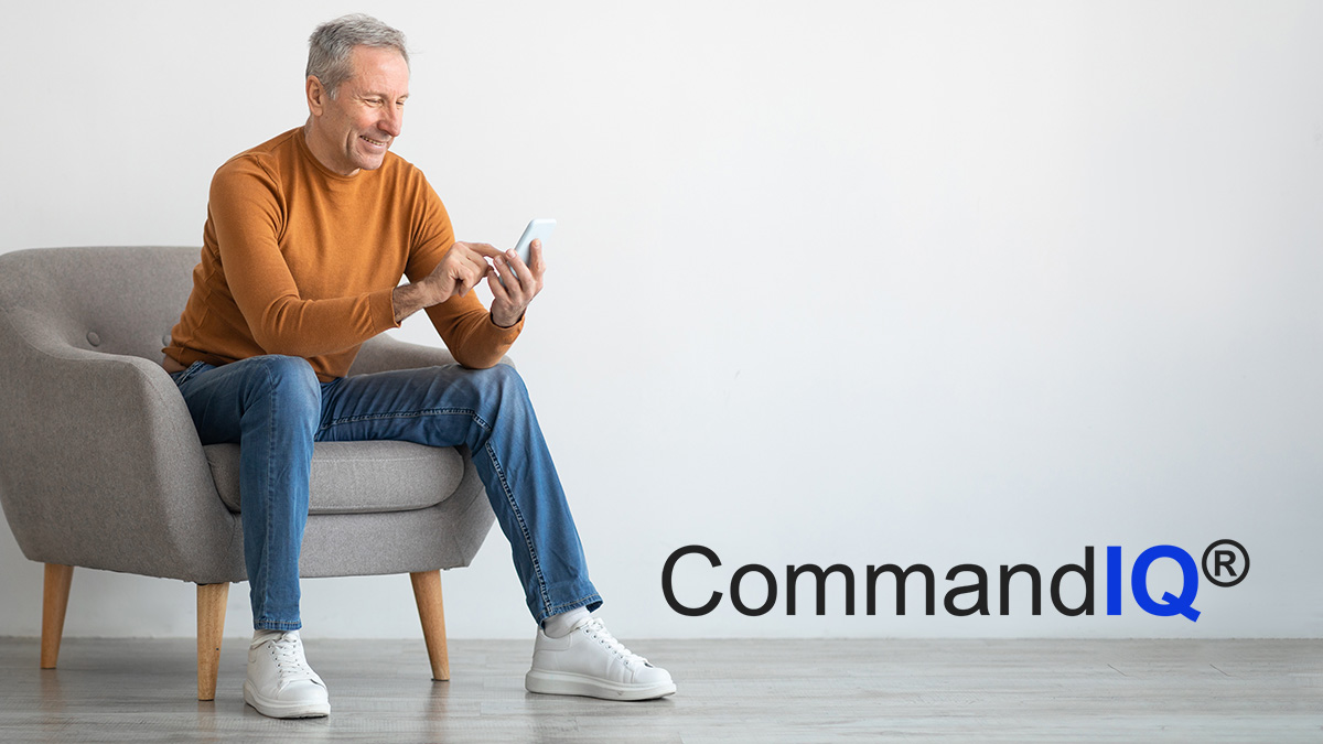 Seated man using mobile device and CommandIQ logo