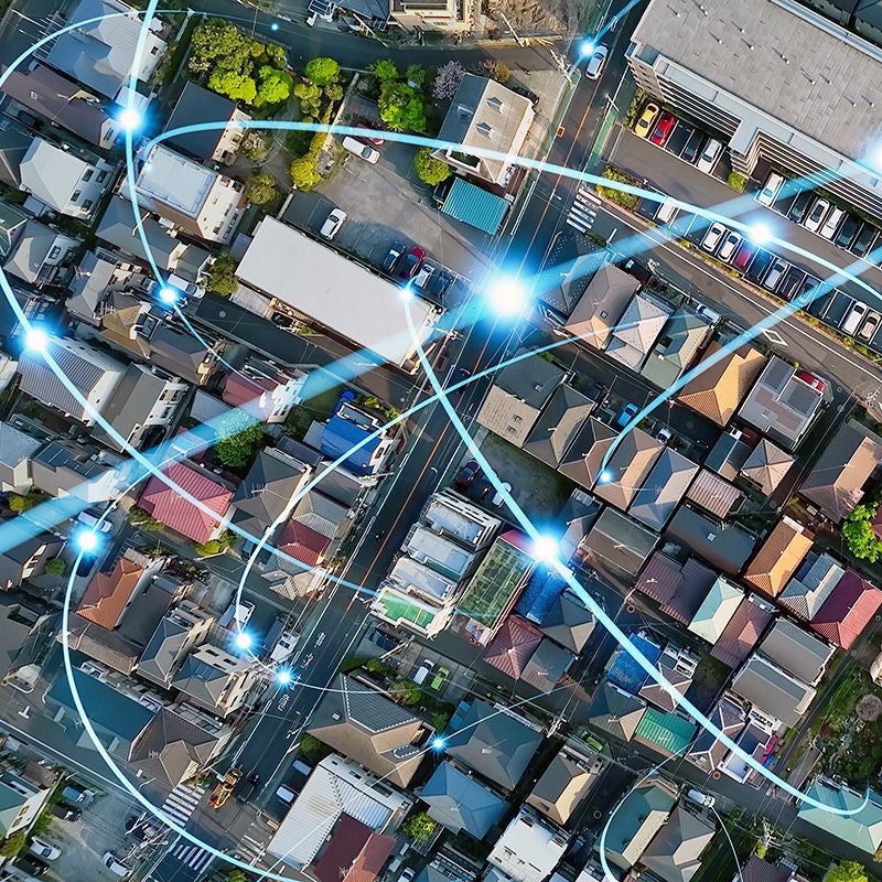 aerial view of town with abstract network overlay