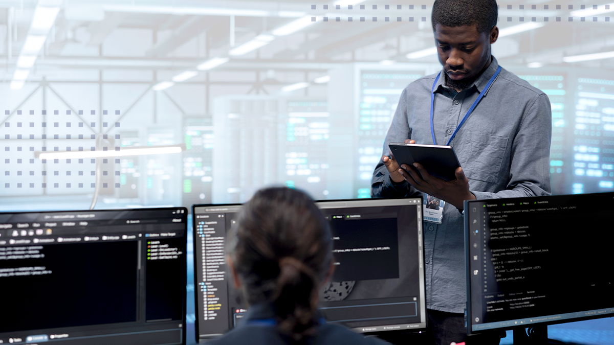 Network engineers using the tab and desktop to find the errors in network in the server room