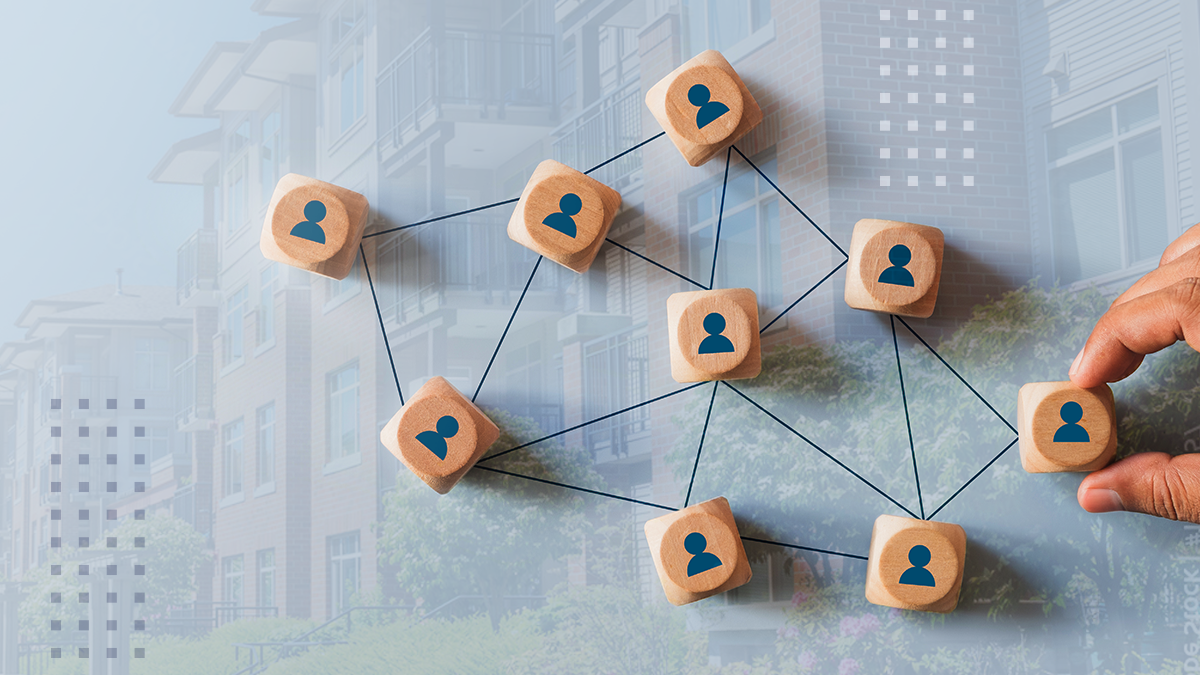 Wooden blocks with person icons are arranged in a network pattern, connected by lines to represent relationships or communication