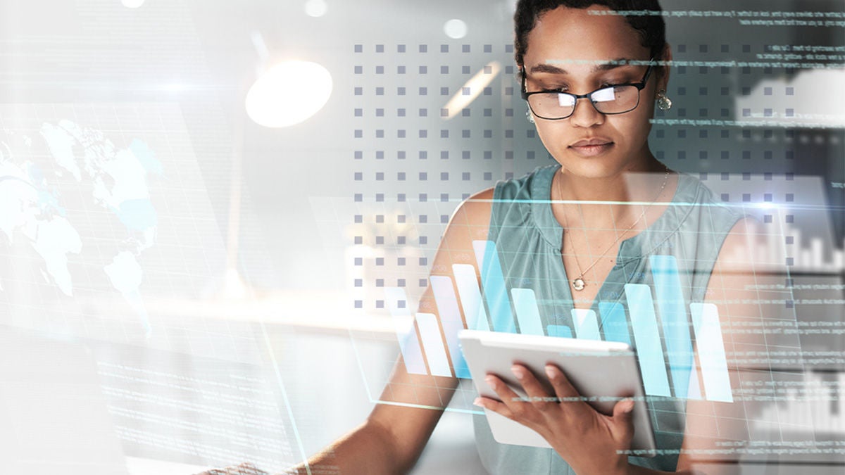 A woman looking at data to boost broadband operations on a digital tablet