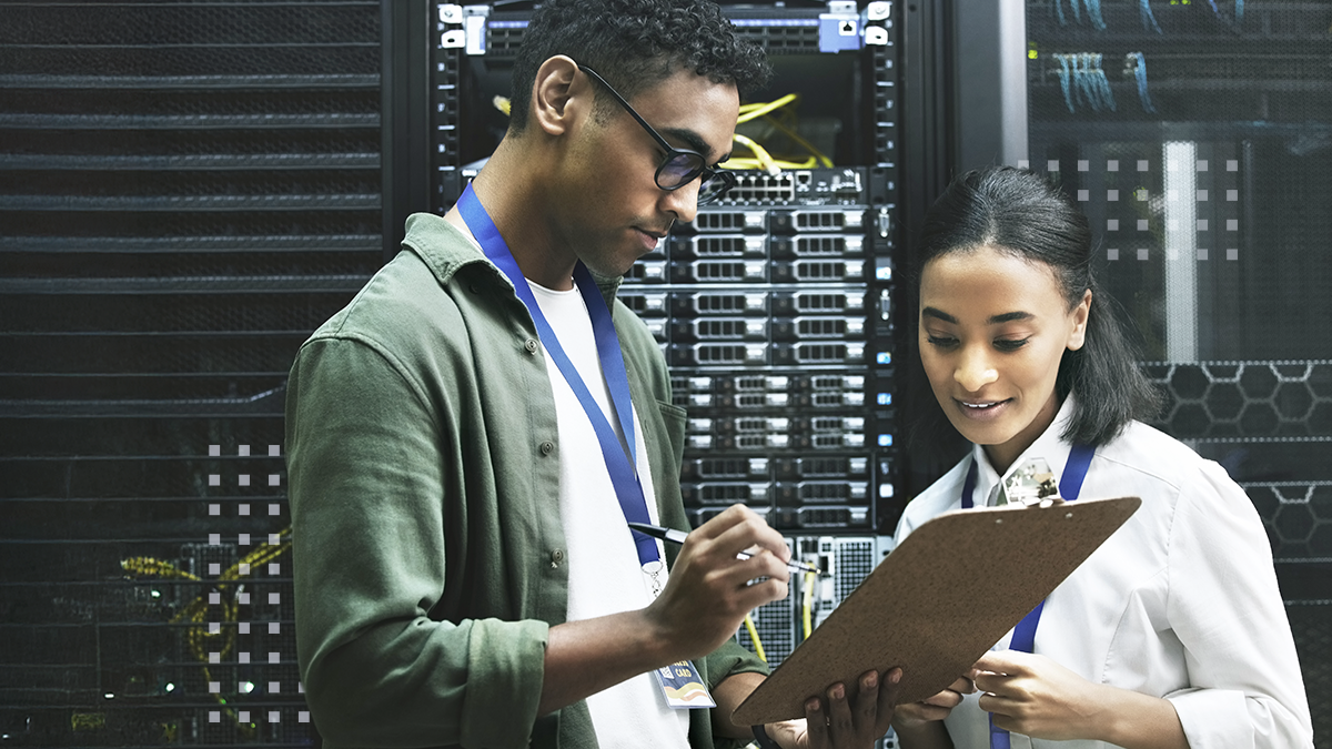 Shot of two technicians working together in a sever room 