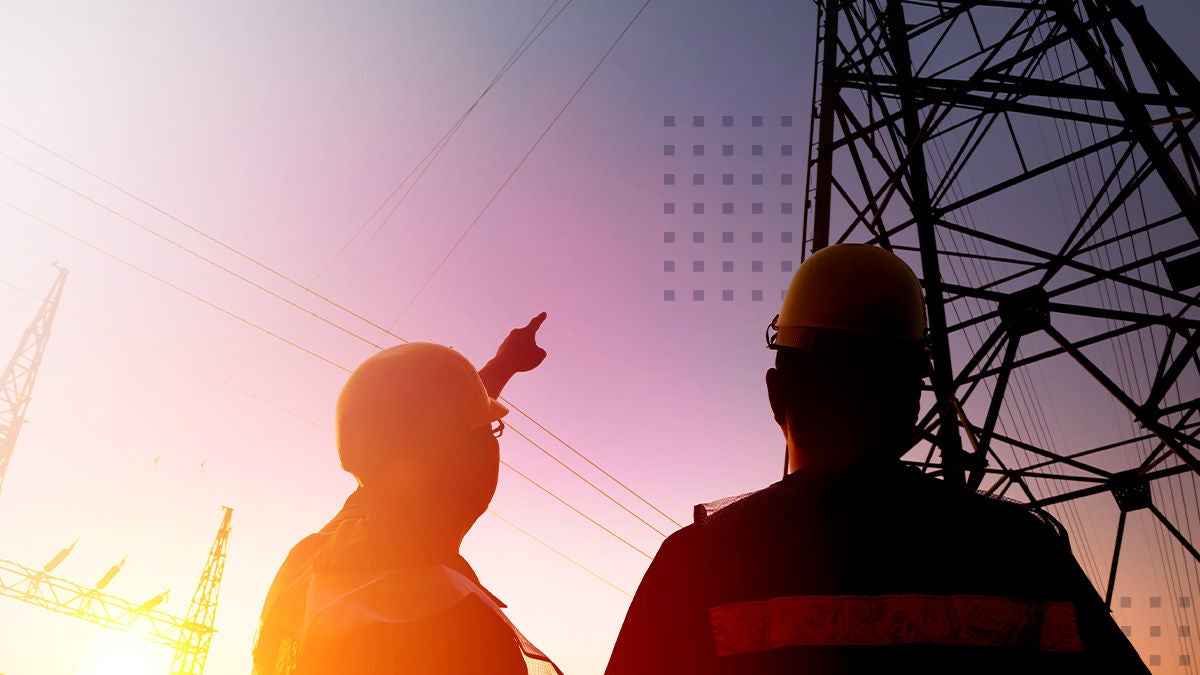 Silhouetted utility workers wearing safety helmets stand near electrical transmission towers at sunset. One worker points toward the power lines, suggesting inspection or discussion of infrastructure. The sky is tinted with warm orange and purple hues, creating a dramatic industrial scene. The text "CalixOne" appears at the top left and "PRESS RELEASE" is shown in a blue banner at the bottom left.