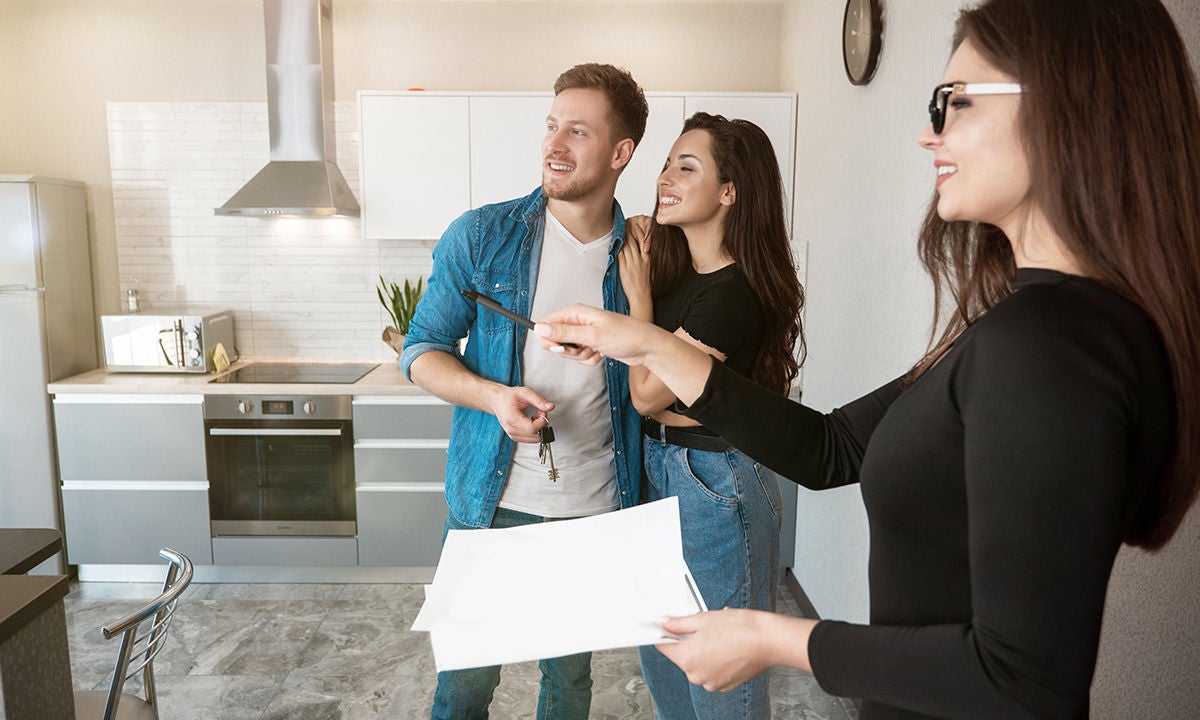 property manager showing apartment to couple
