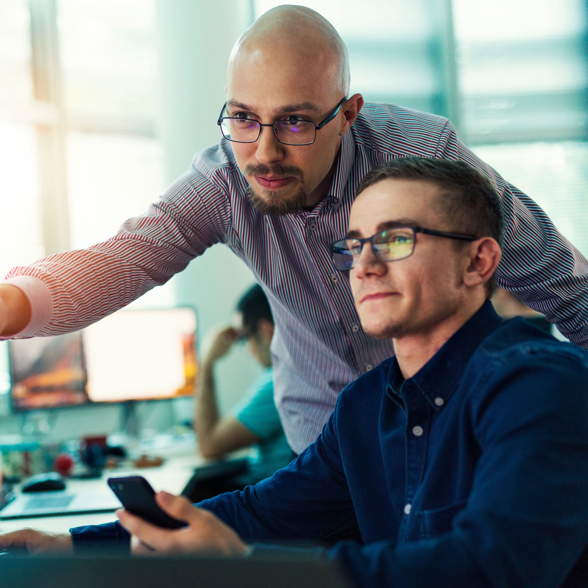 Programmers working in a software developing company office