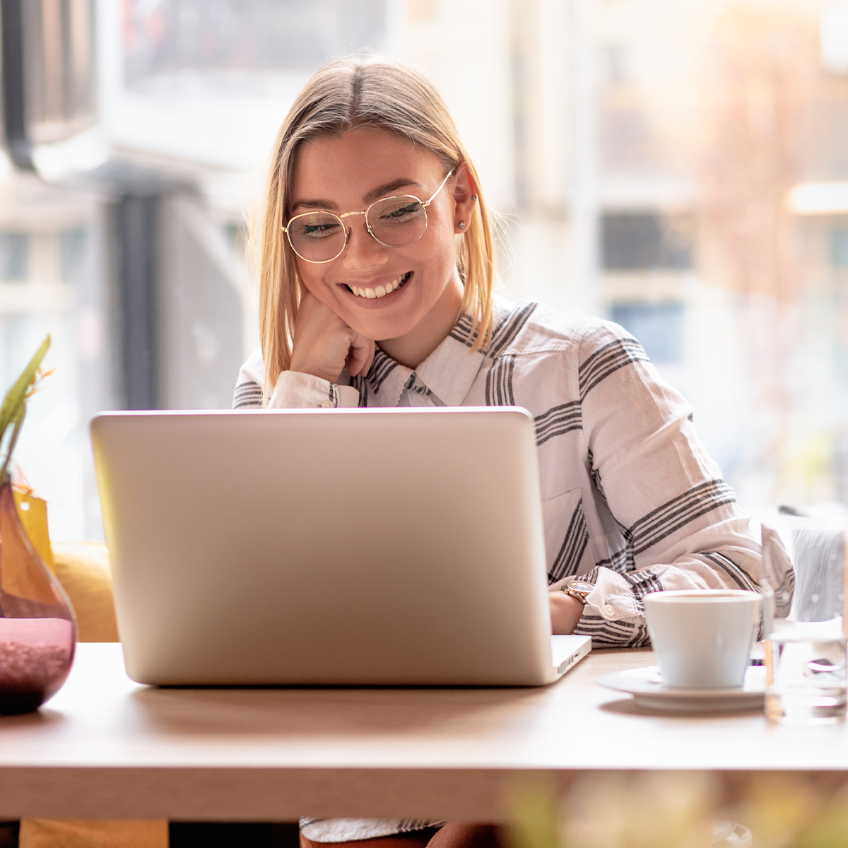 Smiling woman using laptop