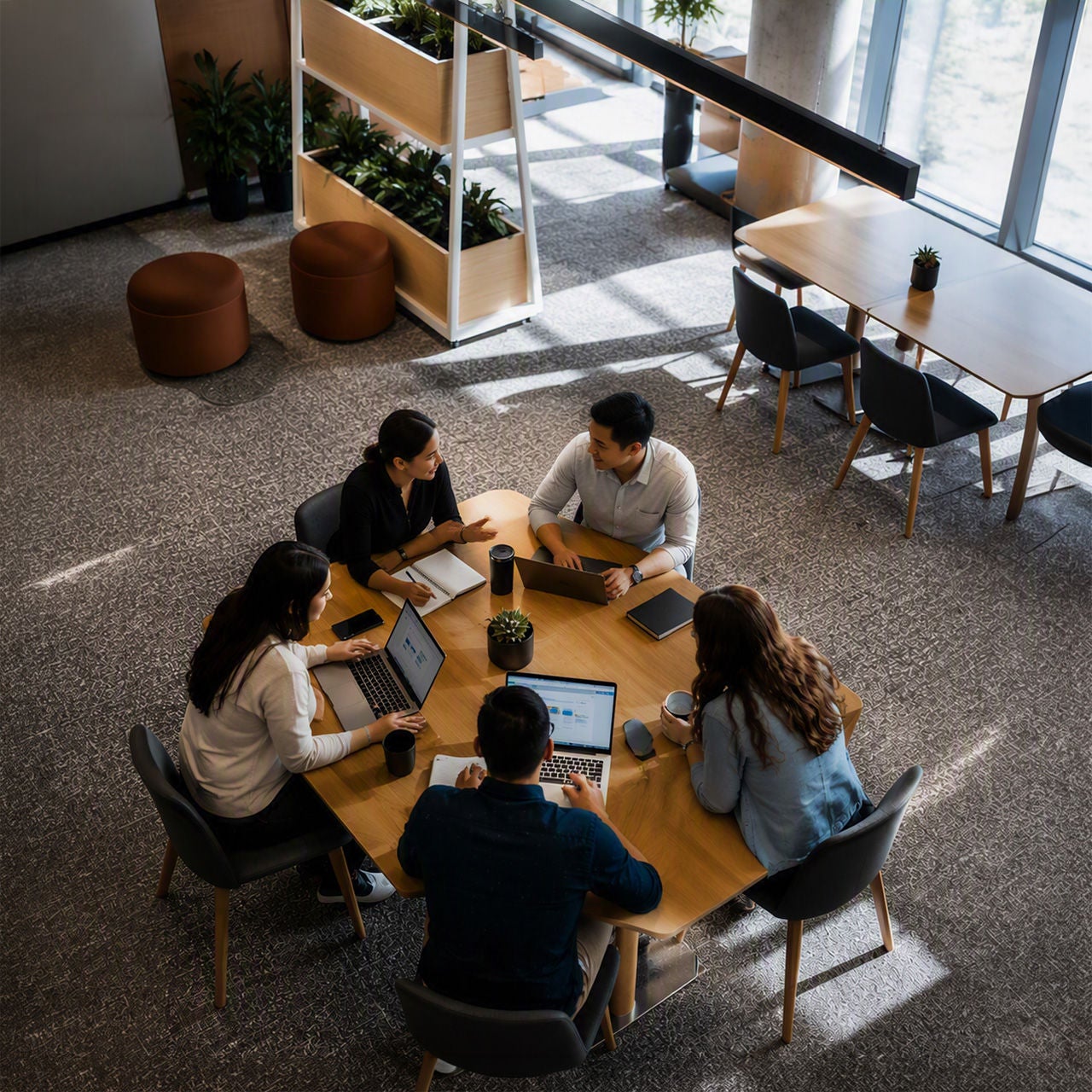 Employees collaborating with laptops