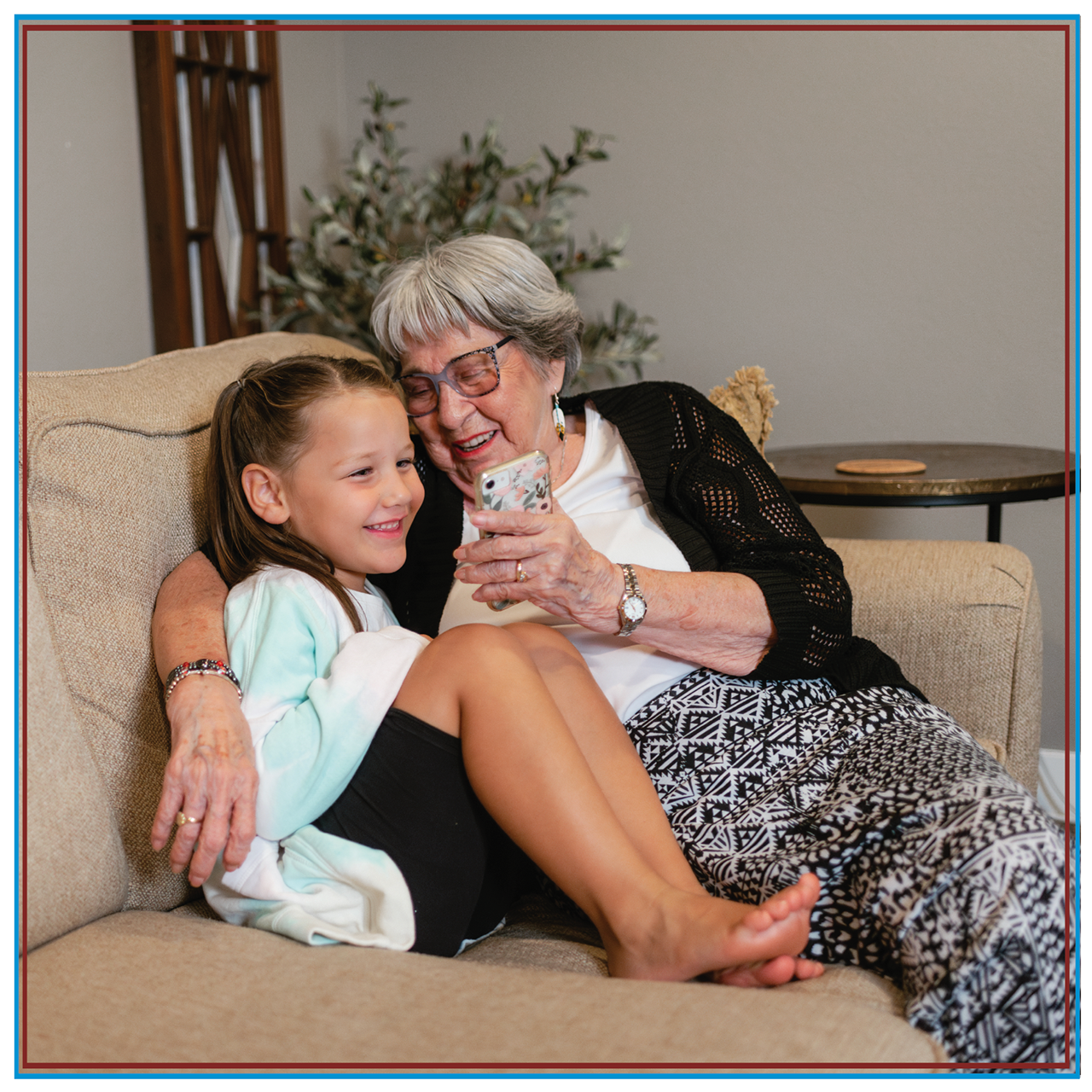tribal-smiling-young-girl-grandmother-looking-at-mobile-screen.png A mother and her two daughters using tribal broadband on a tablet