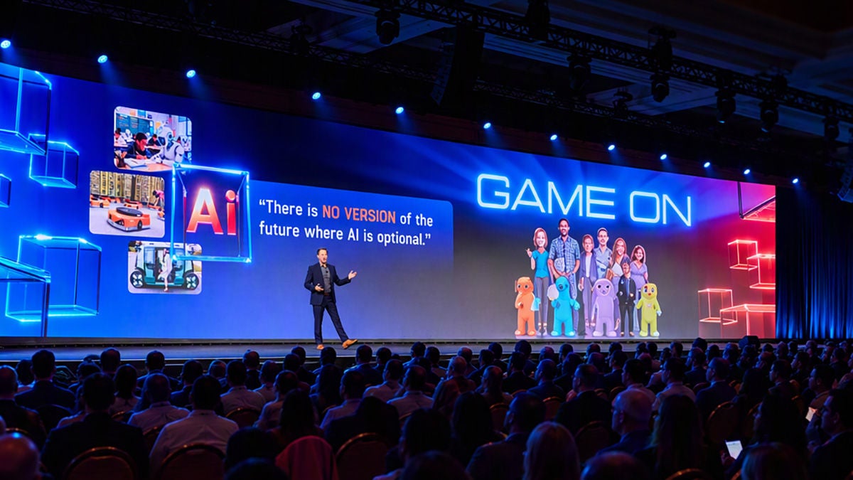 Michael Weening on main stage with "Game On" on screen behind him