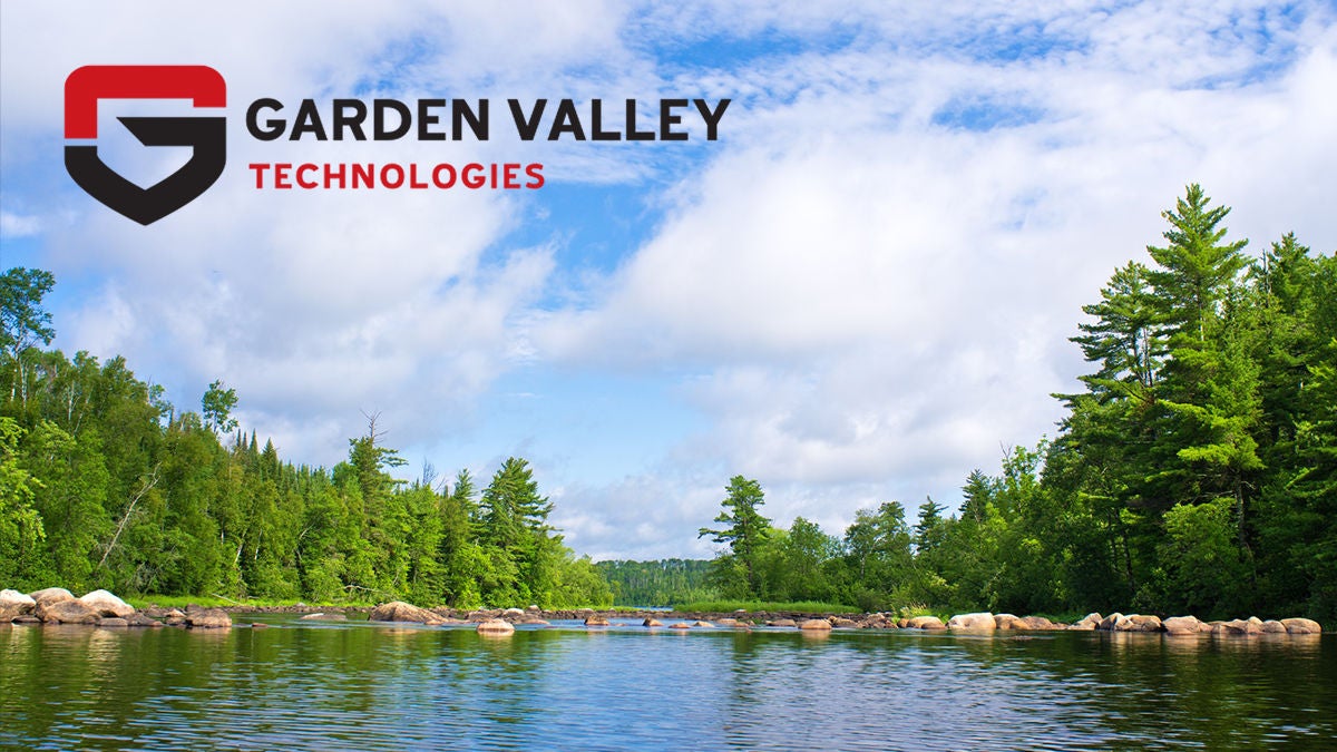 A clear and vibrant river flows through a lush green forest under a partly cloudy sky. The Garden Valley Technologies name and shield emblem are prominently displayed in the upper left corner. The scene evokes tranquility and natural beauty, with the company name and logo clearly visible.