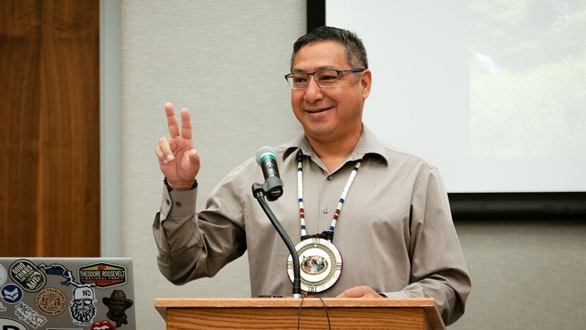 A man speaking at a community tribal event