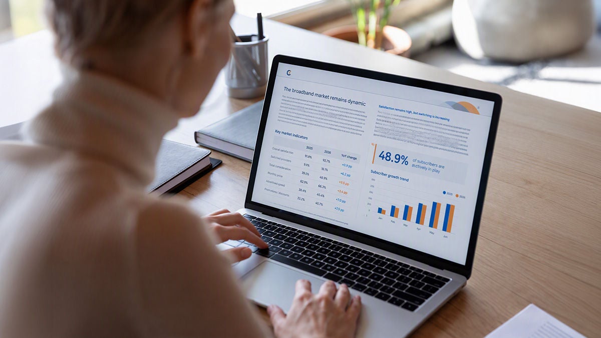 Business person reading a report on laptop