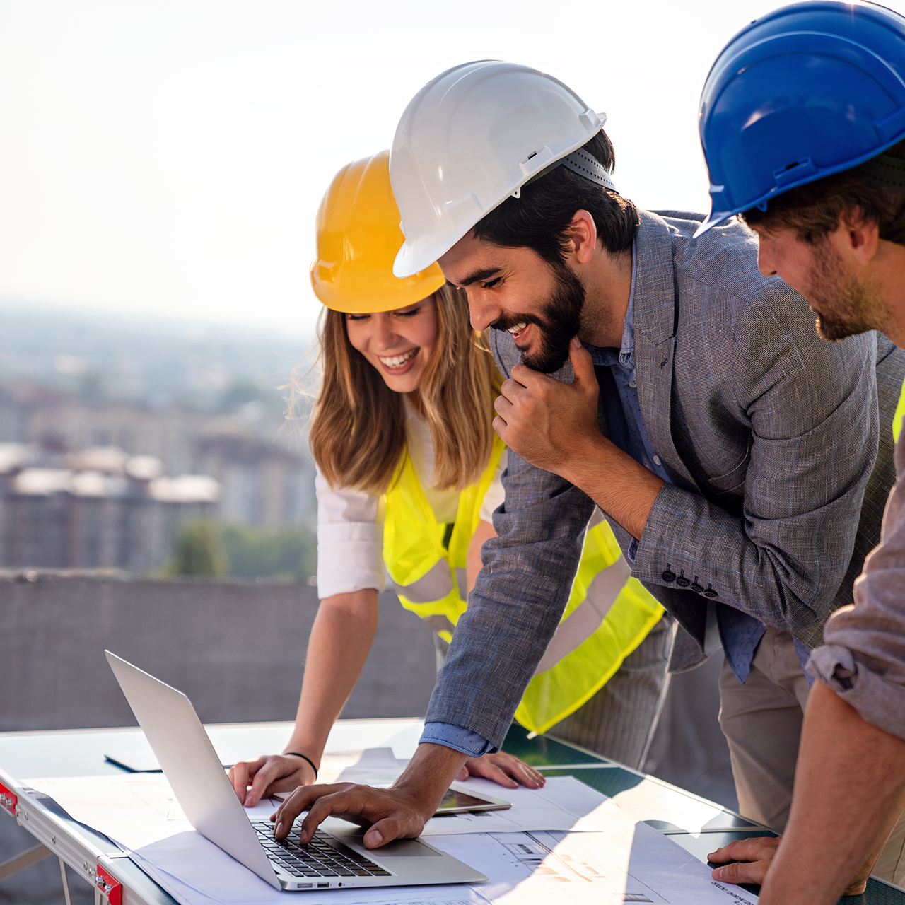 Team of architects and engineer in group on construciton site check documents and business