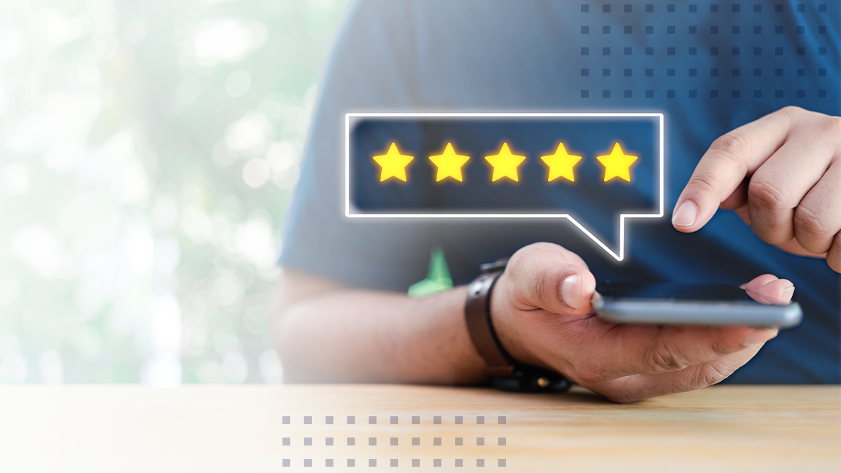 Man holding cell phone with 5 star review to boost NPS