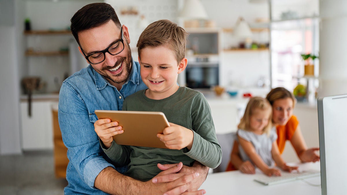 Family with digital devices at home. 