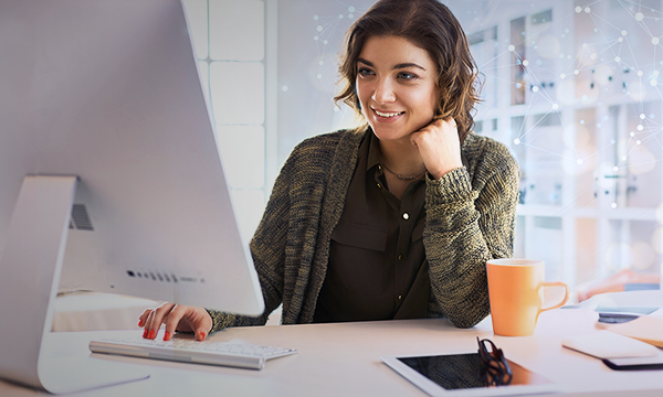 Young smiling beautiful woman using a computer in the office