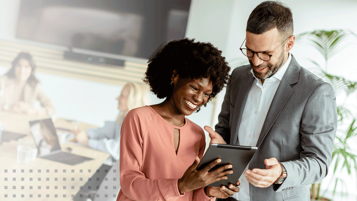 Business people using tablet discussing ideas in office