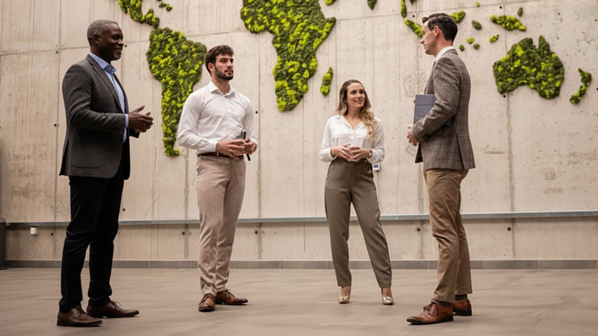 business people meeting in front of green map of world