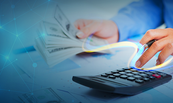 an accountant holding a cash in one hand and doing calculations using a calculator