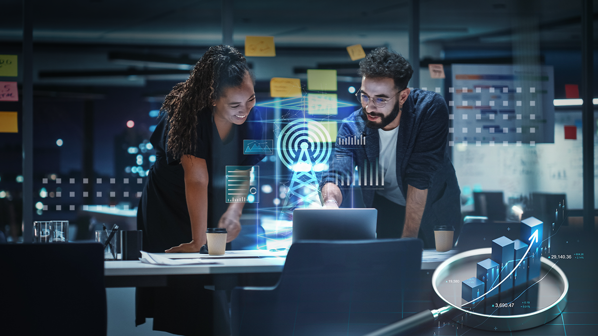 man and woman in office looking at ai rendering of signal tower