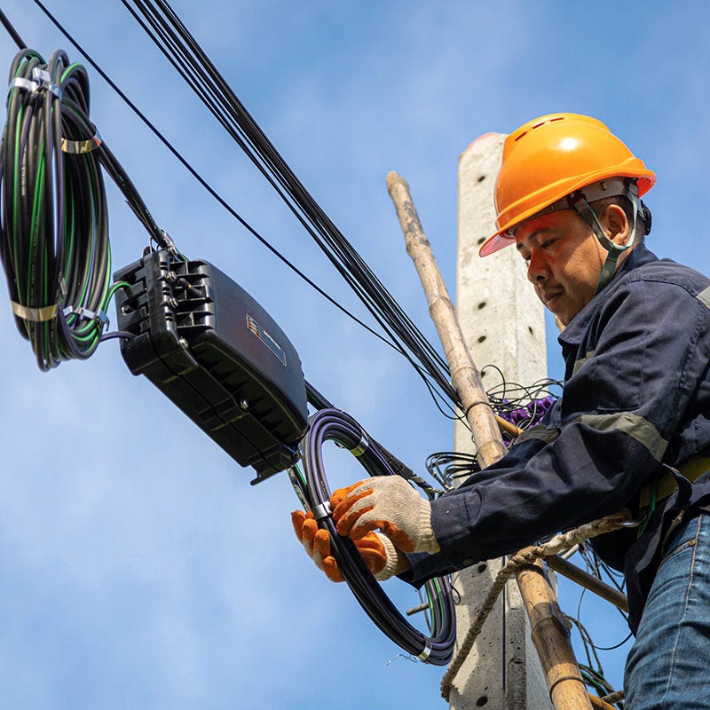 Cable technician on pole