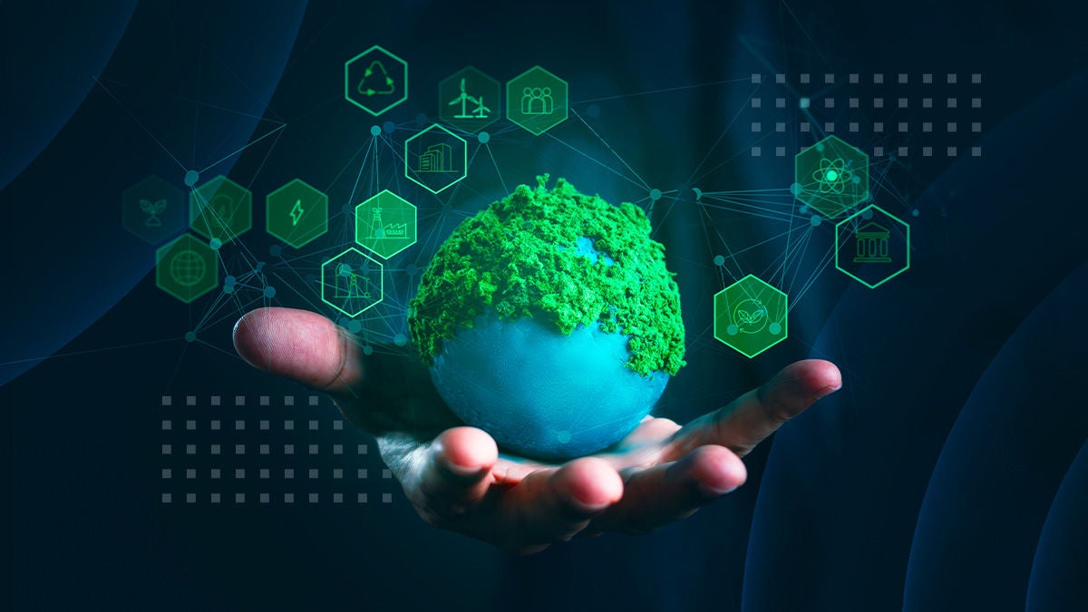 A human hand holds a small globe covered in lush green moss, symbolizing an eco-friendly planet. Floating hexagonal icons around the globe represent renewable energy, recycling, transportation, and sustainable industry. The dark blue background and glowing teal graphics create a futuristic, digital interface feel. The composition emphasizes innovation, environmental responsibility, and green technology solutions.