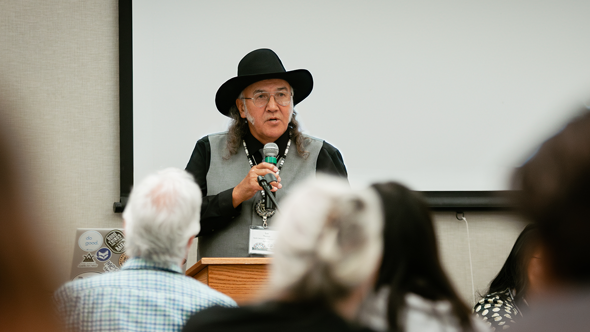 An older man speaking about tribal broadband at a meeting