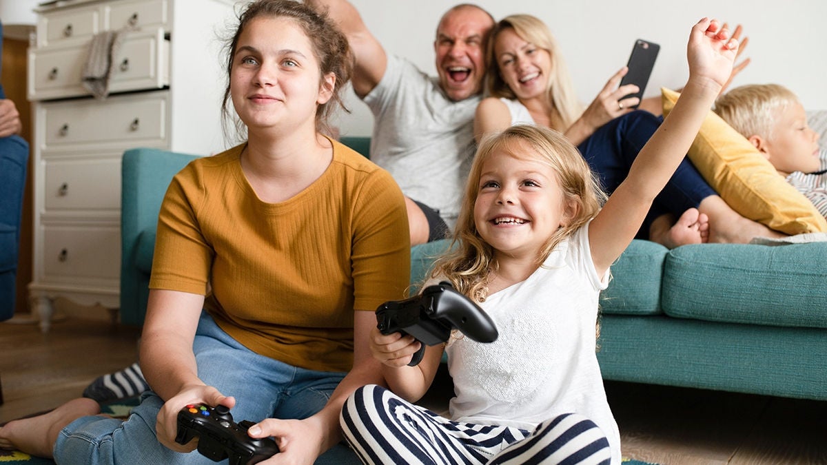Happy family playing video gaming console