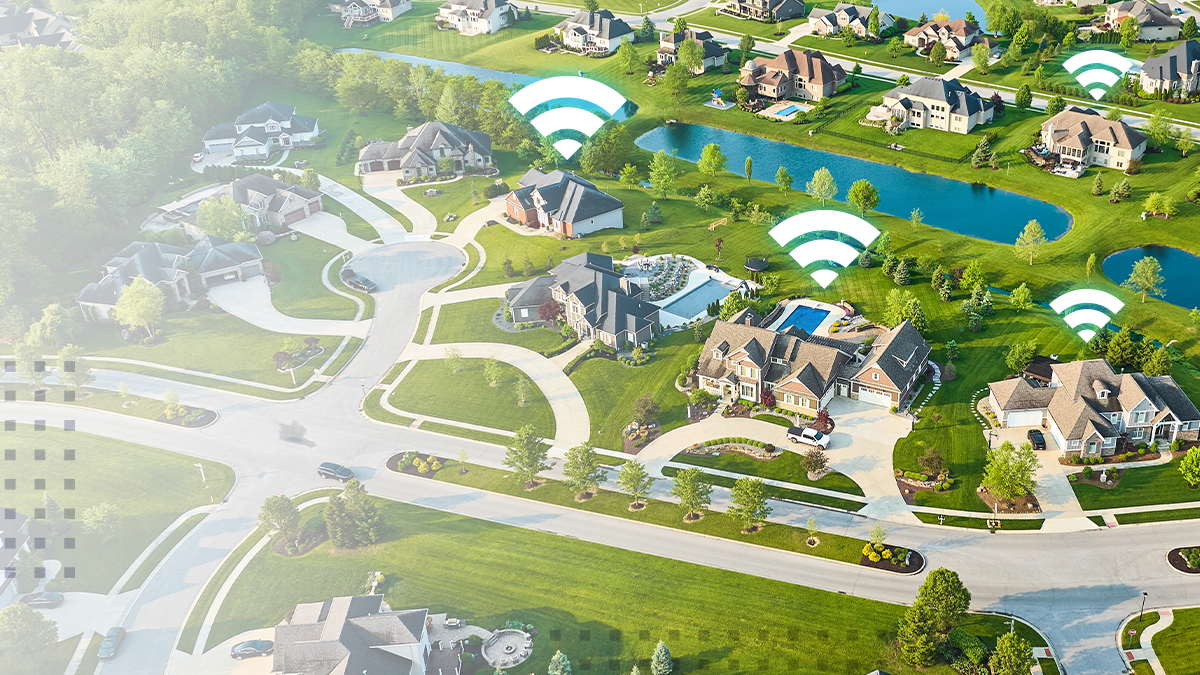 Aerial view of a suburban residential neighborhood featuring multiple houses with visible Wi-Fi symbols, indicating wireless internet coverage
