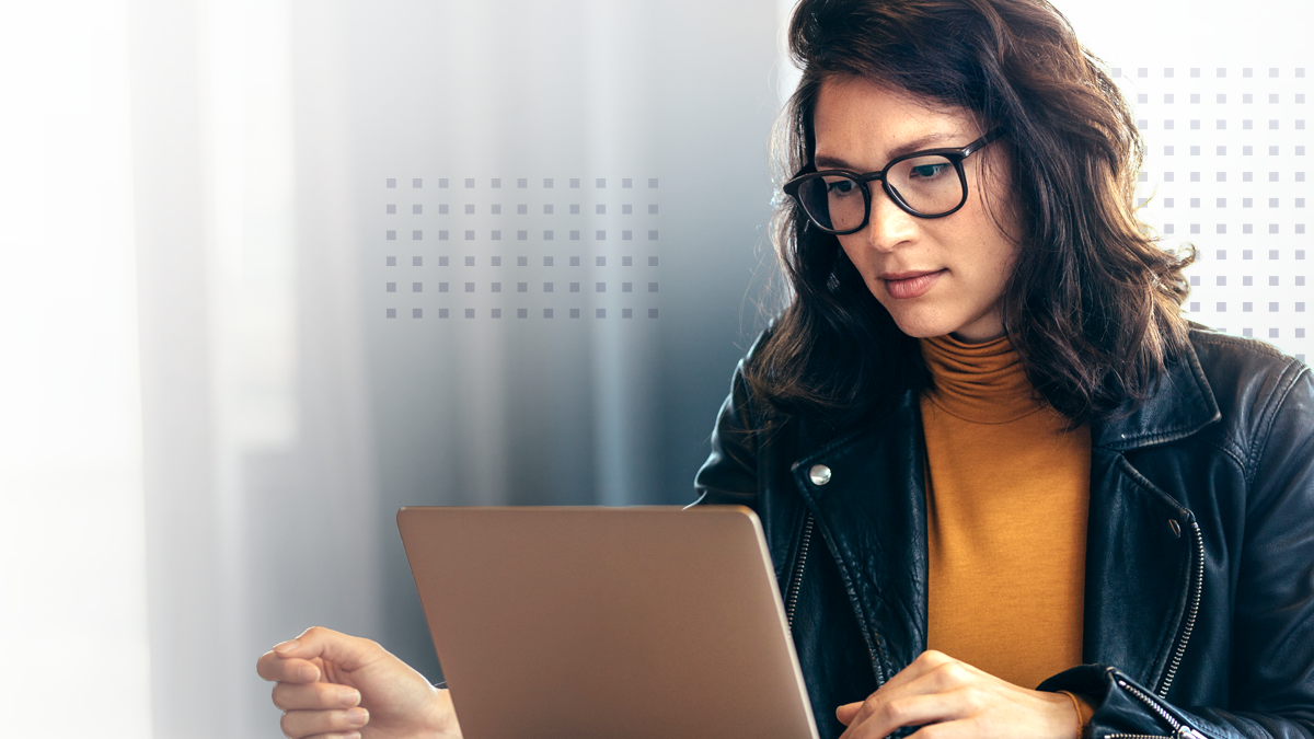A woman viewing AI-powered marketing data on a laptop