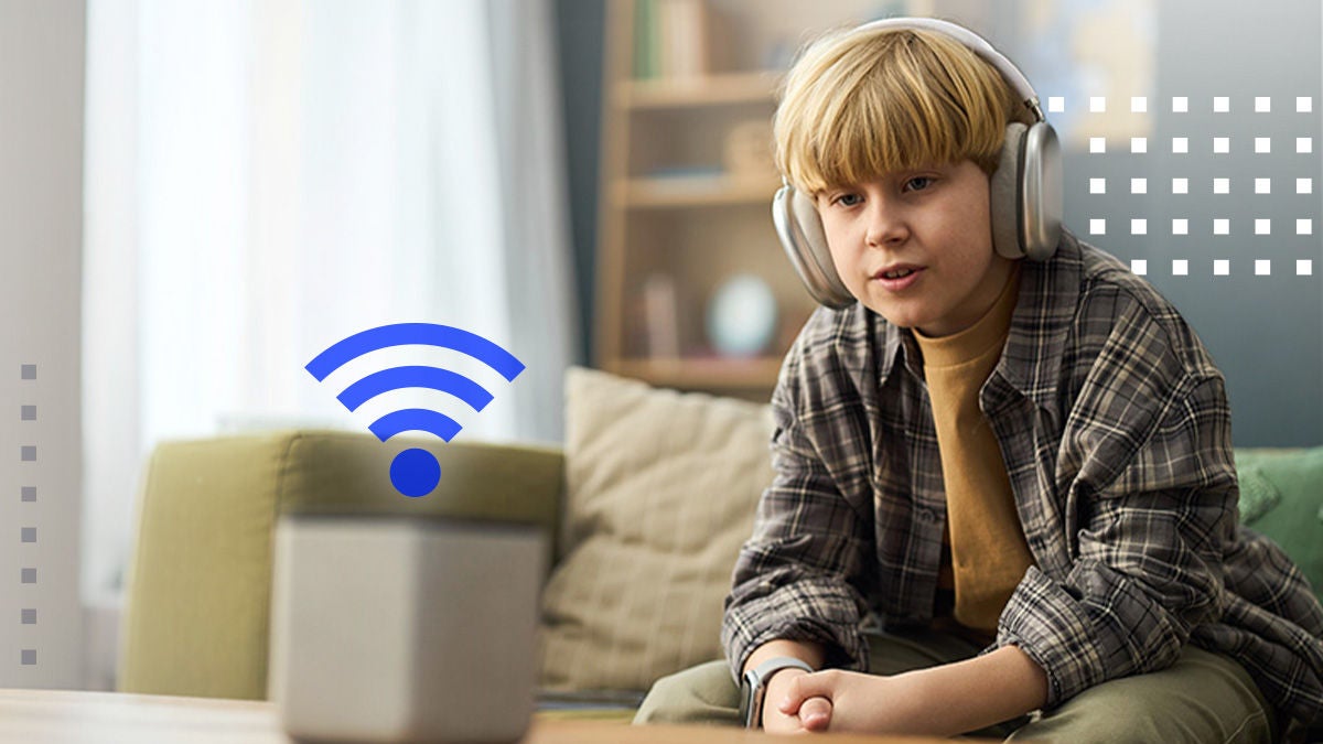 A young boy wearing large over-ear headphones sits on a couch in a modern living room. In front of him is a smart speaker, highlighted by a blue wireless signal icon. Soft furnishings and neutral colors create a cozy, contemporary home setting. The image suggests streaming audio, internet connectivity, and casual technology use.