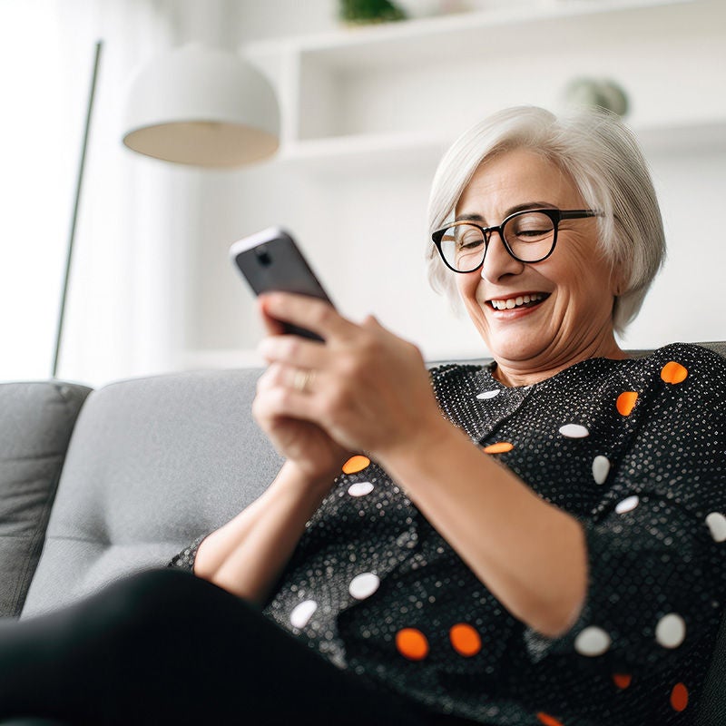 smiling woman with phone at home