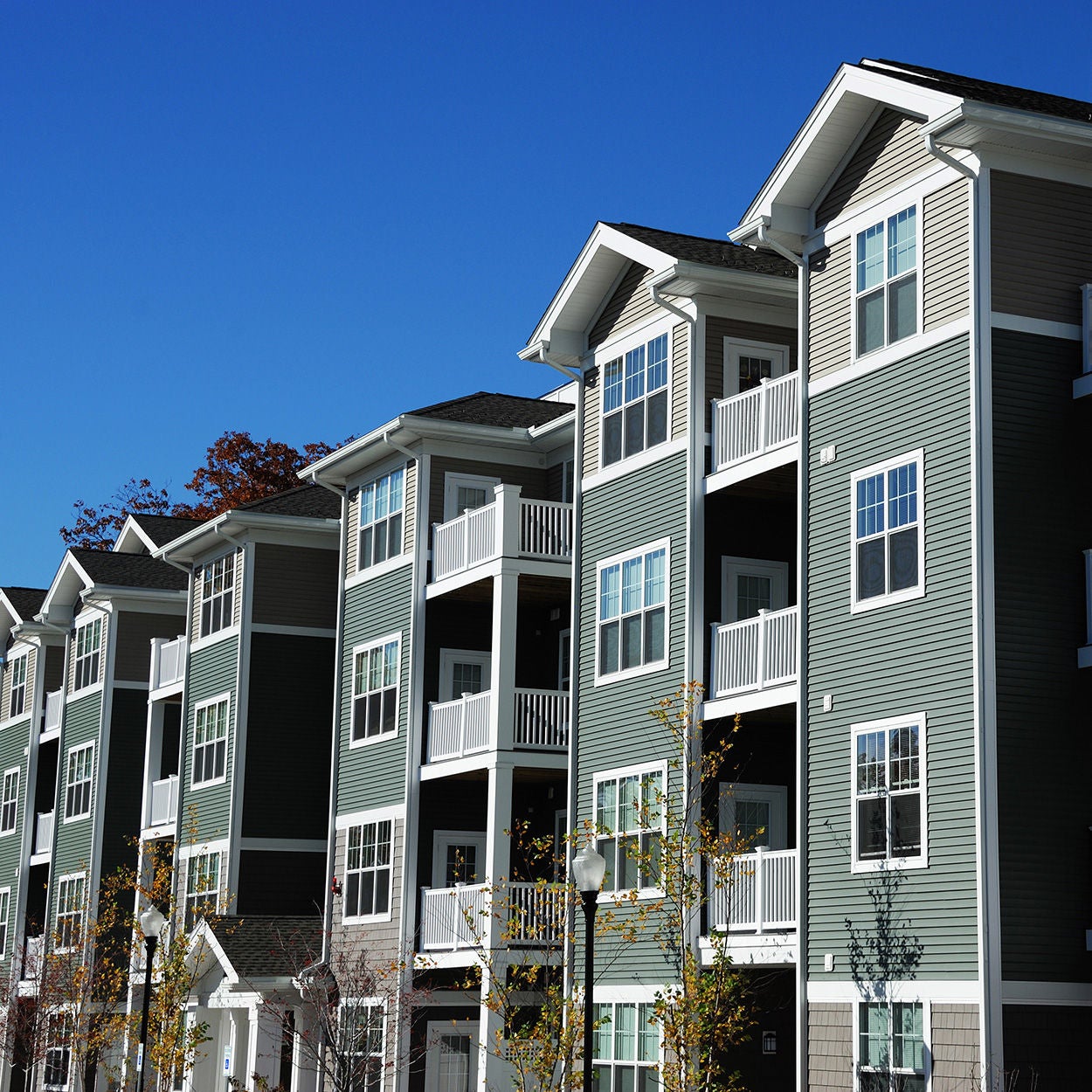 Apartment building in sunny day with blue sky in the background