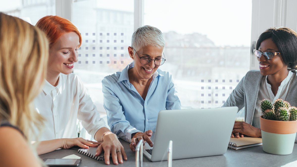 happy business women working together using laptop in the modern office