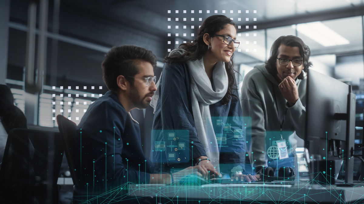 group of three young software engineers use computer to discuss a technological project in modern office