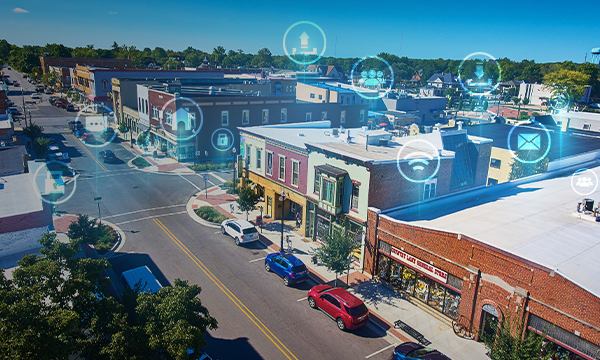 Aerial of shops on a street in a rural city with connectivity concept