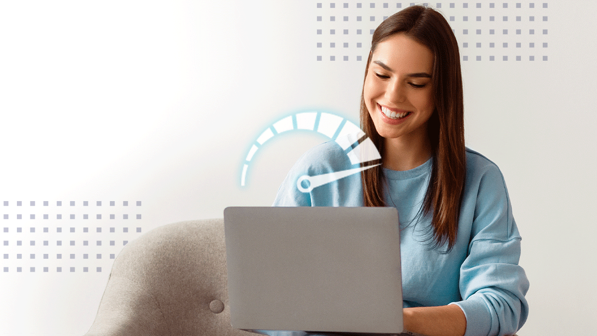 Smiling woman working on laptop in home office space